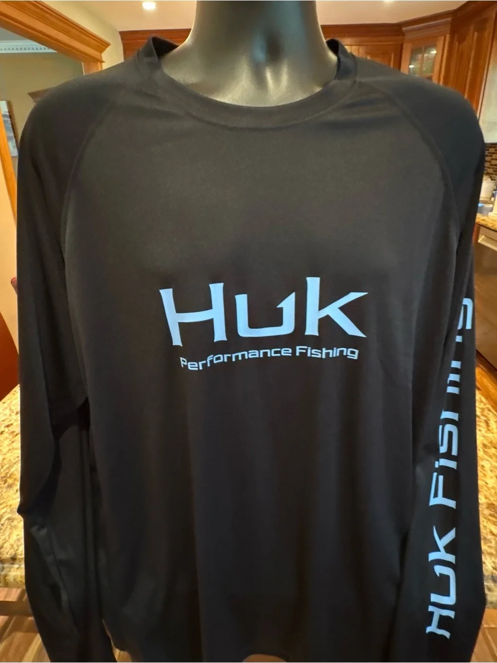 Huk men’s long sleeve performance Fishing Shirt. Sharp Black with blue logos.